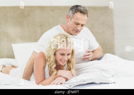 Cute couple reading the news Stock Photo