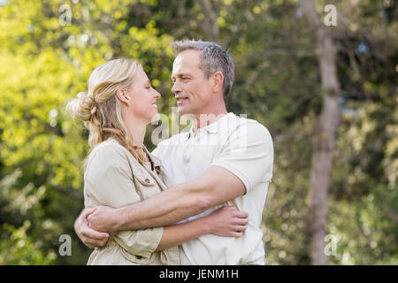 Cute couple hugging with arms around Stock Photo