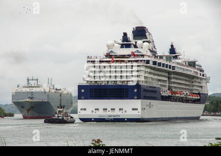 Celebrity Infinity Cruise ship and car carrier cargo ship in the Panama Canal Stock Photo