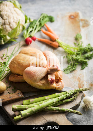 Raw chicken on chopping board Stock Photo