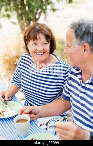 Mature couple having meal outdoor Stock Photo