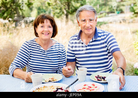 Mature couple having meal outdoor Stock Photo