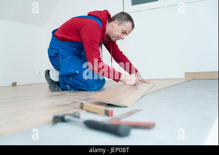 Man lying laminate floor Stock Photo