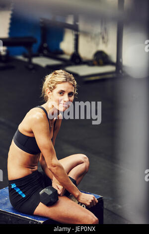 Young woman with dumbbell Stock Photo