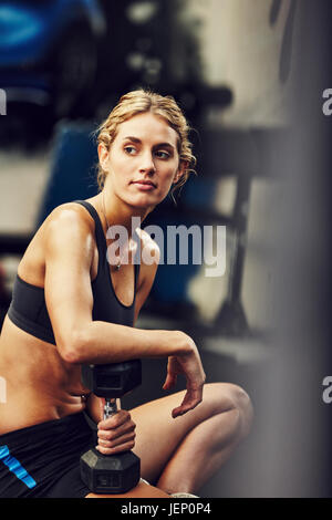 Young woman with dumbbell Stock Photo