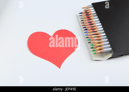 Love your arts and creativity, Box with color pencils near in heart shape. Colorful pencils on white background. Happy valentine's day 14 february. To Stock Photo