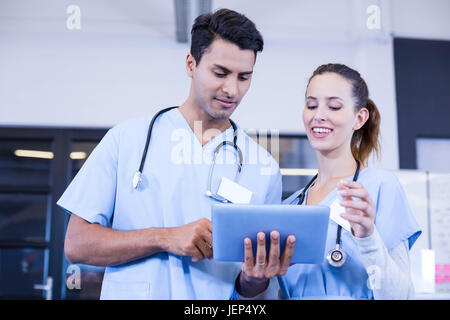 Doctors using digital tablet and smiling Stock Photo