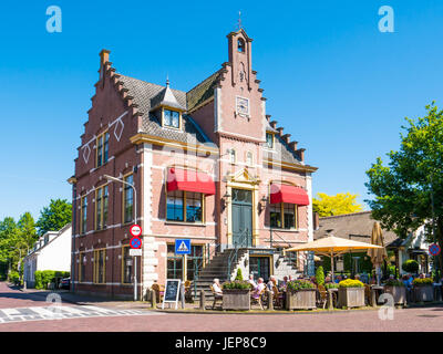 People relaxing on outdoor terrace of restaurant in former town hall of Laren, North Holland, Netherlands Stock Photo