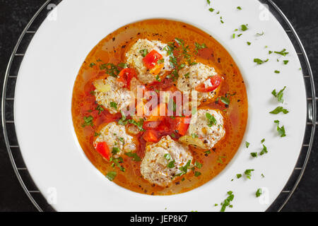 Top view of plate with meatballs soup, traditional plate of the Romanian cuisine. Stock Photo