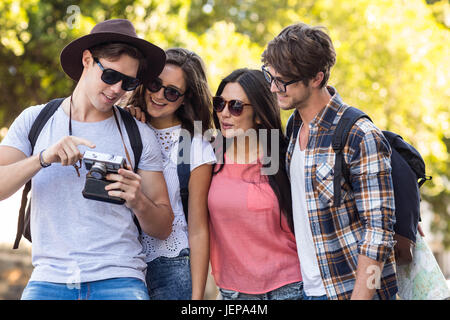 hip friends looking at digital camera Stock Photo