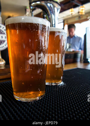 TWO PINTS OF BITTER AWAIT DRINKING IN A LONDON PUB Stock Photo