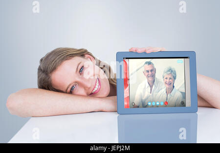 Composite image of woman showing tablet pc Stock Photo