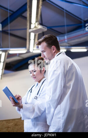 Doctors discussing over digital tablet Stock Photo