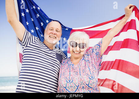 Senior couple holding american flag together Stock Photo