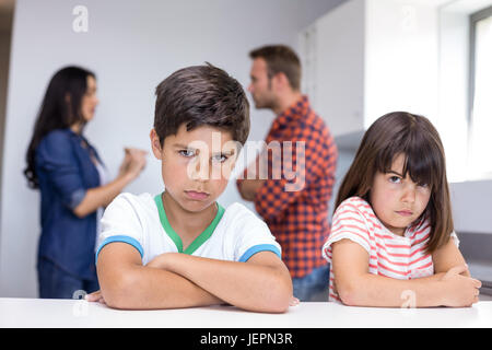 Parents arguing in front of children Stock Photo