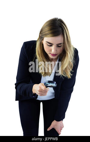 Woman using magnifying glass Stock Photo