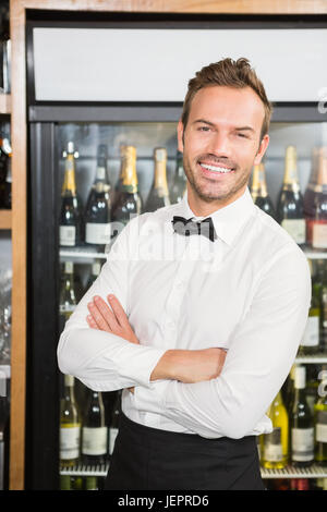 Handsome barman with arms folded Stock Photo
