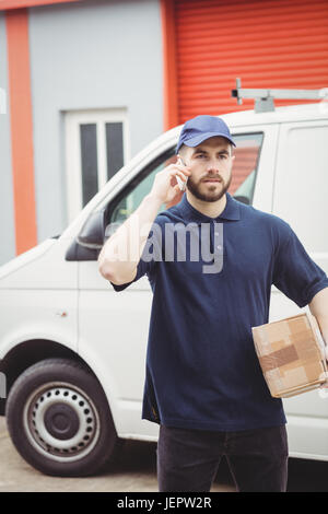 Delivery man making a phone call Stock Photo
