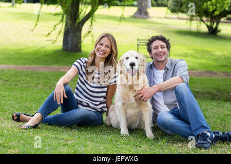 Couple with their dog in the park Stock Photo