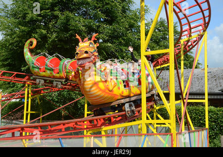 Kliplev, Denmark - June 10 , 2017:  Coller coaster in dragon shape amues the audience on a market place. Stock Photo