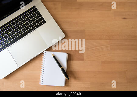 Laptop, Apple MacBook Pro with pen and notepad on desk Stock Photo