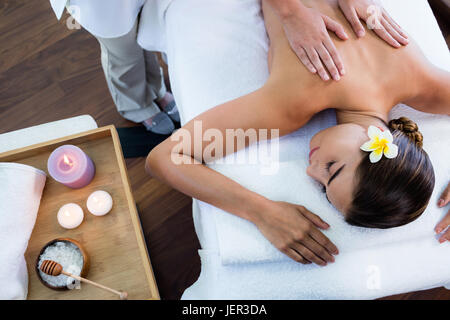 Masseuse giving massage to relax woman Stock Photo