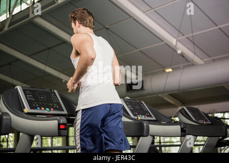 Man running on thread mill Stock Photo