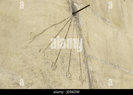 Old sundial on a wall, detail of an old solar time marker Stock Photo