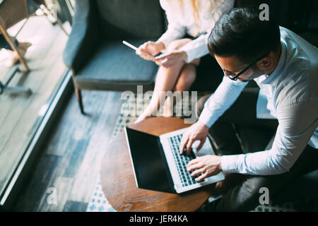 Image of two young successful business partners working at meeting Stock Photo