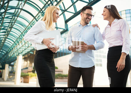 Picture of young attractive business partners standing outdoor Stock Photo