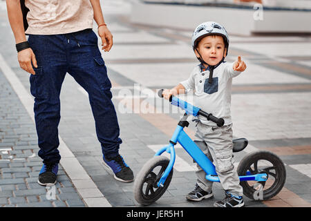 Father teaching his son to ride a bike Stock Photo