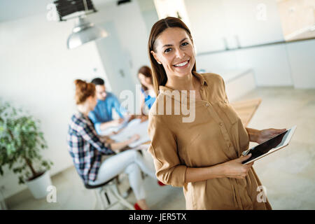 Image of young beautiful business woman holding tablet Stock Photo