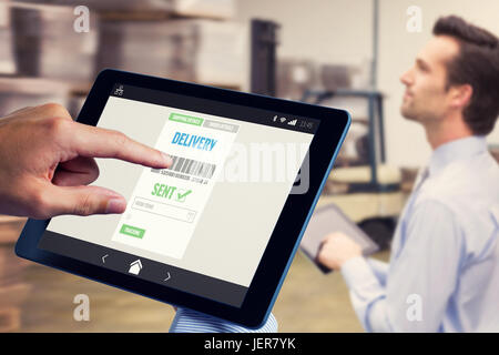 Composite image of man using tablet pc Stock Photo