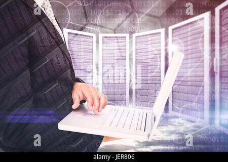 Composite image of businessman holding laptop Stock Photo