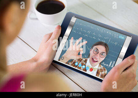 Composite image of woman using tablet pc Stock Photo