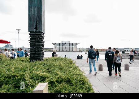 Copenhagen, Denmark - August 12, 2016: Tourists in Amaliehaven waterfront with Opera House building on background in Copenhagen a cloudy day of summer Stock Photo