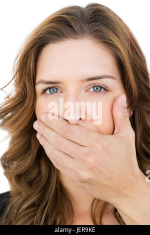 Hand covering young womans mouth Stock Photo