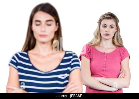 Upset female friends with arms crossed Stock Photo