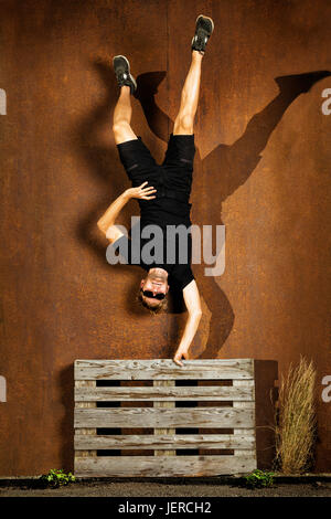 Man doing handstand Stock Photo