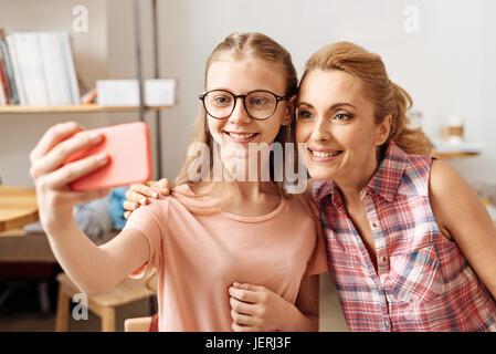 Sweet mother and daughter posing for a selfie Stock Photo