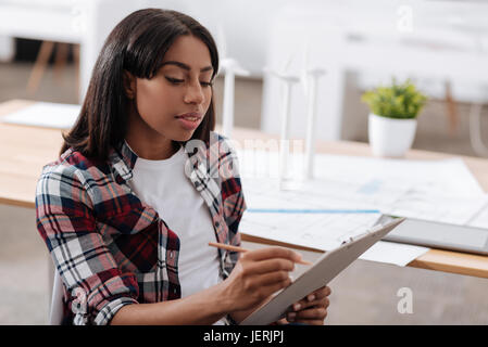 Good looking pleasant woman taking notes Stock Photo
