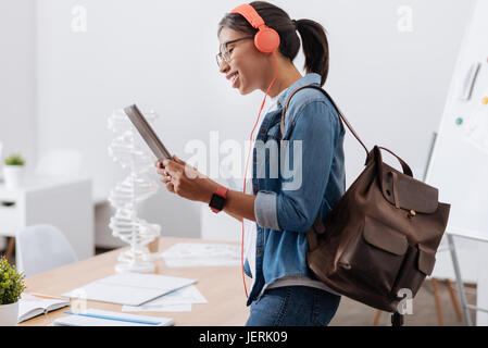 Cheerful nice student listening to music Stock Photo