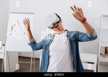 Beautiful young woman experiencing virtual reality Stock Photo