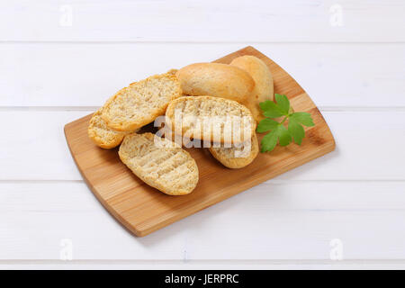 pile of crispy rusks on wooden cutting board Stock Photo