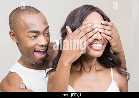 Young man covering womans eyes Stock Photo