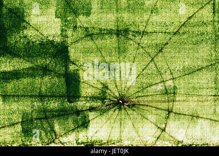 Crack pattern on broken green glass surface, abstract grunge texture Stock Photo