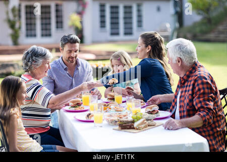 Happy family having lunch in the garden Stock Photo