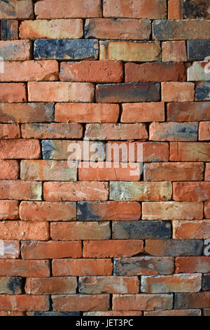 Rough red brown brick wall background texture without cement close up, side view Stock Photo