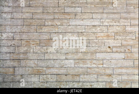 Wall of white and gray adarce travertine stone brick blocks, close up background texture, side view Stock Photo
