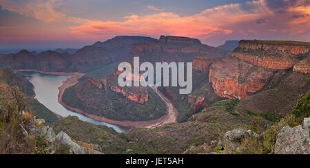 View over the Blyde River Canyon and the Three Rondavels in South Africa at sunset. Stock Photo